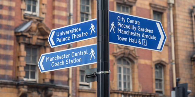 Signpost pointing towards the University of Manchester