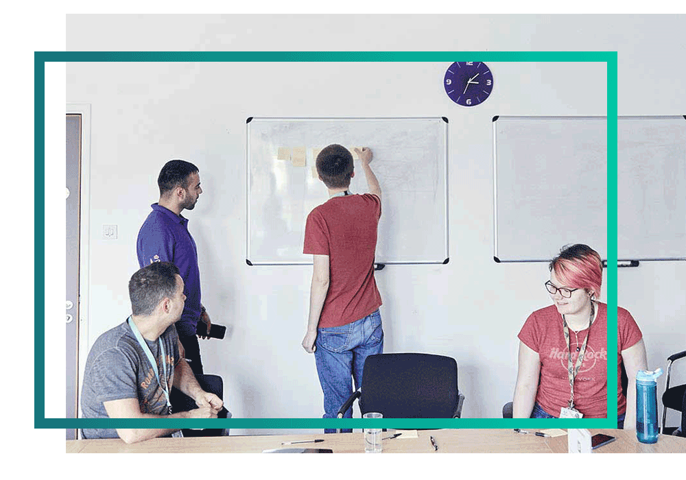 Team of multi-cloud experts working on a whiteboard